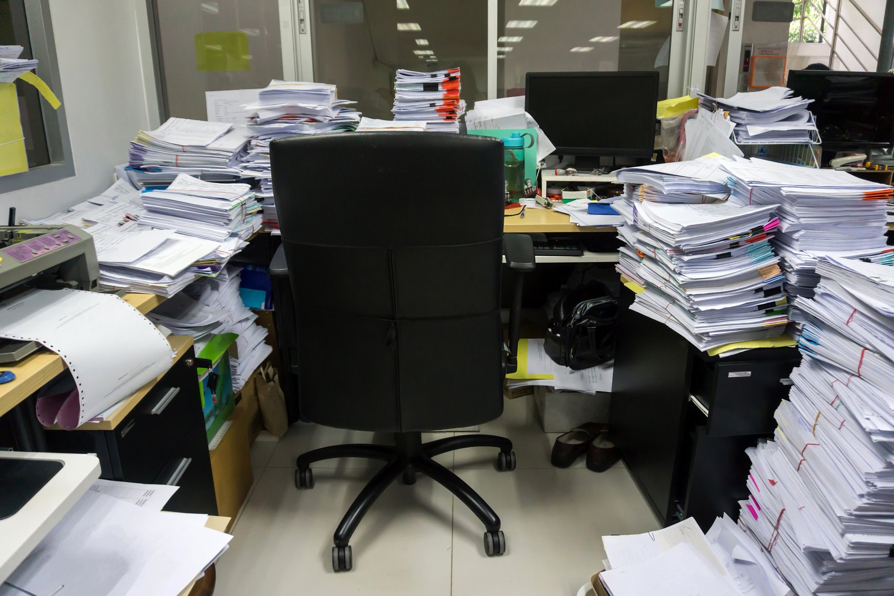 Busy, messy and cluttered workplace, full of documents